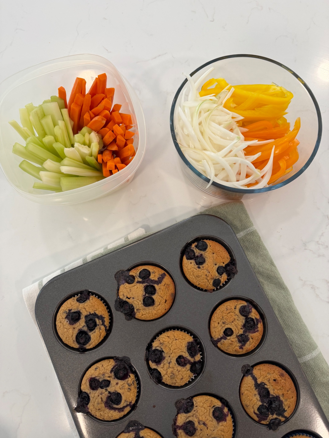 Fresh vegetables and muffins prepared in a family kitchen