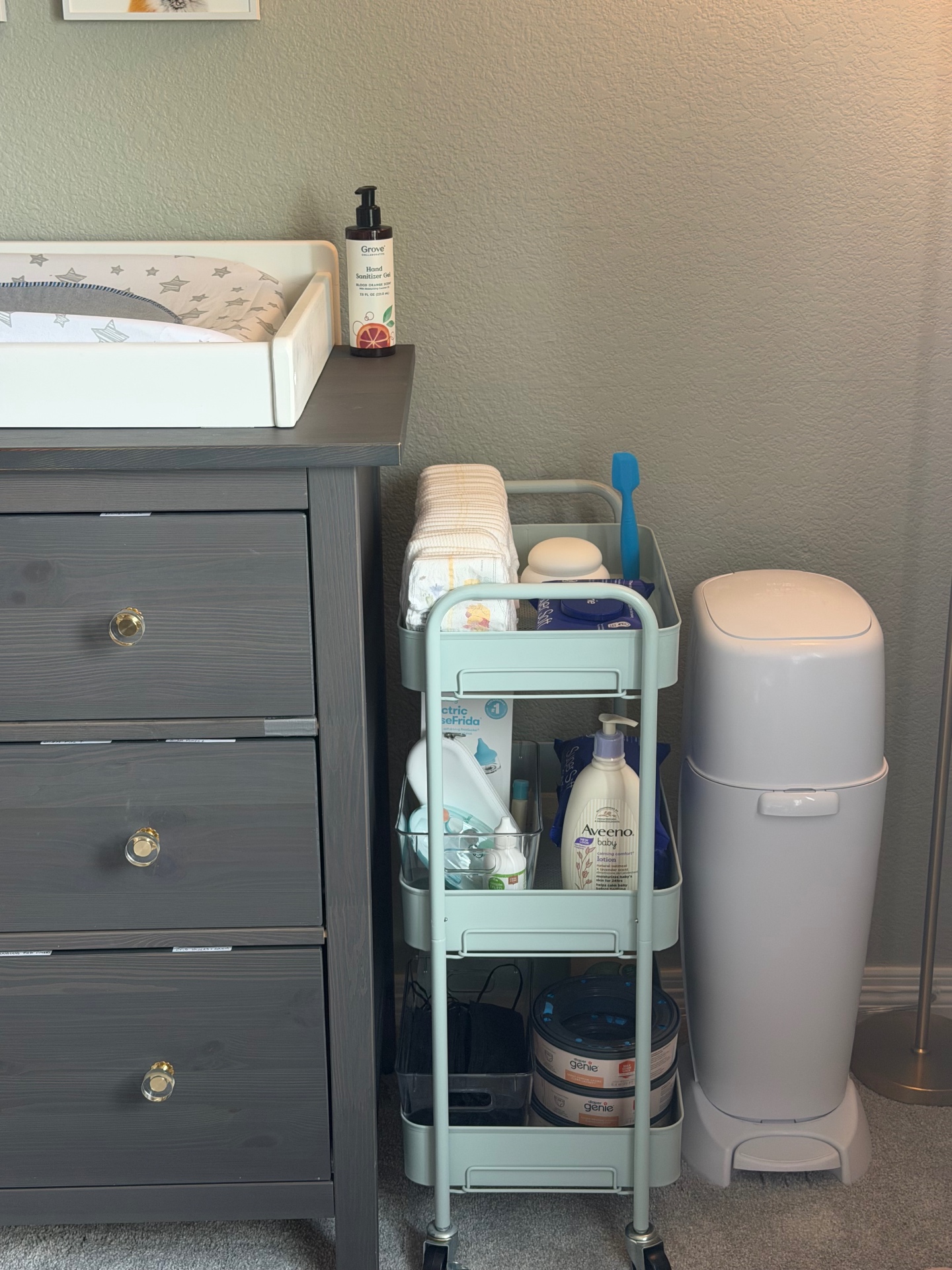 Refreshed nursery corner with changing table, organized cart, and baby essentials